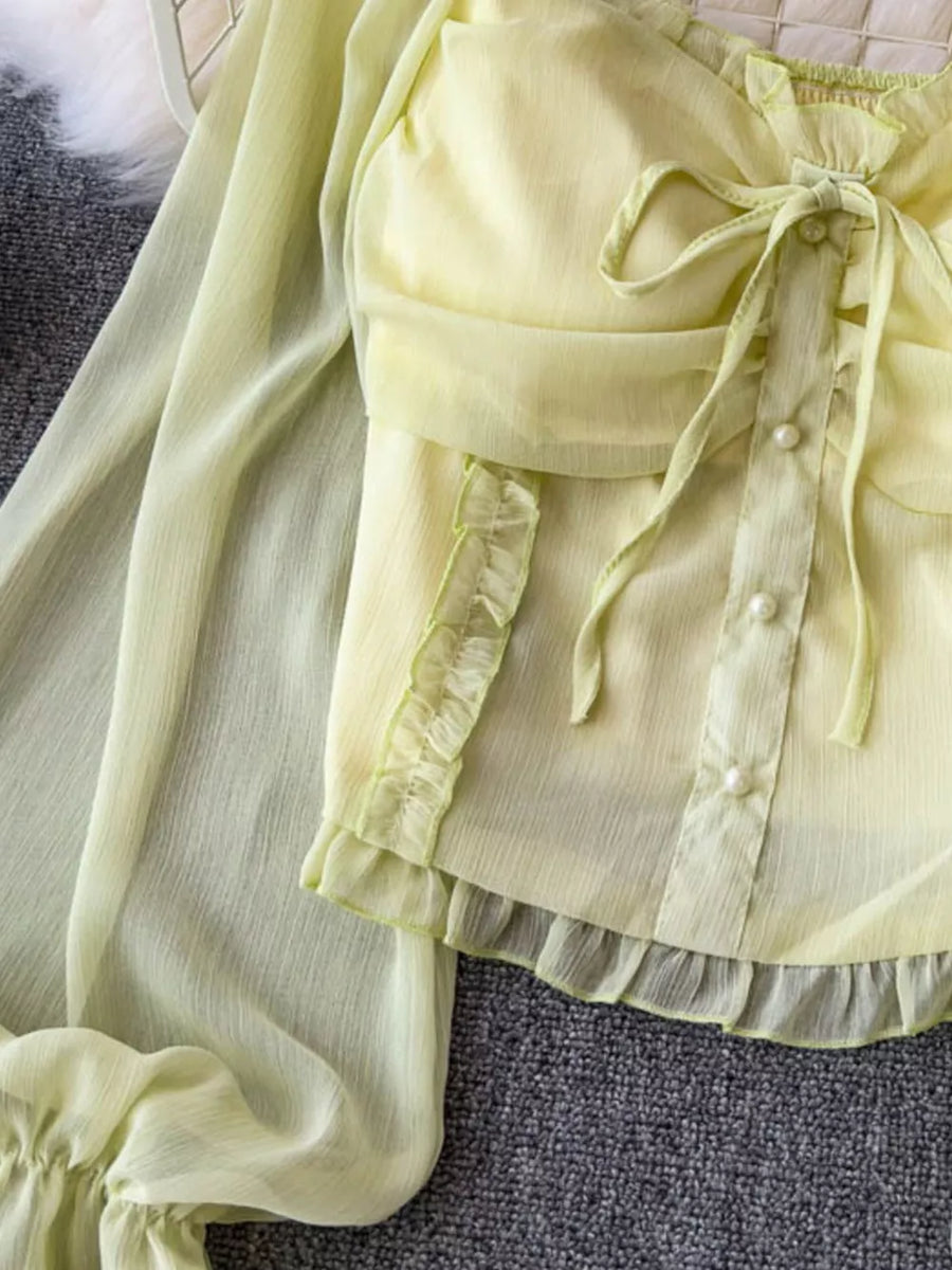 Yellow green maternity blouse with ruffled sleeves, pearl buttons, and a decorative bow.