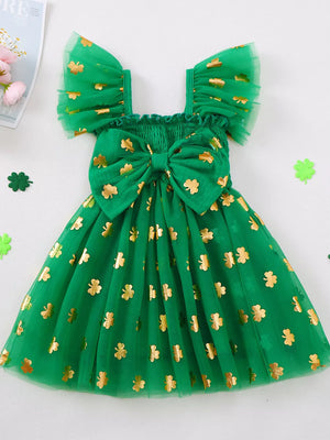 Green tulle dress with gold shamrock print, smocked bodice, bow, and flutter sleeves.