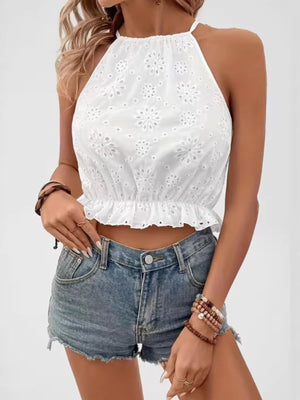 White eyelet embroidered halter cami with ruffled hem and cutout details.