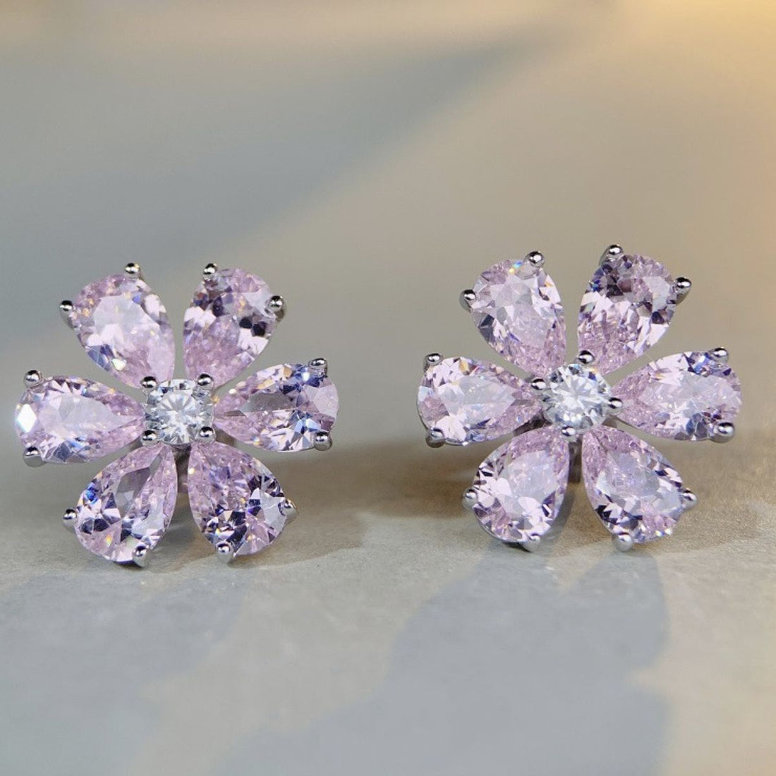 light pink earrings featuring zircon stones and floral
