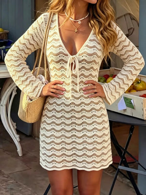Crochet mini dress with white wave pattern and tie front, long sleeves.