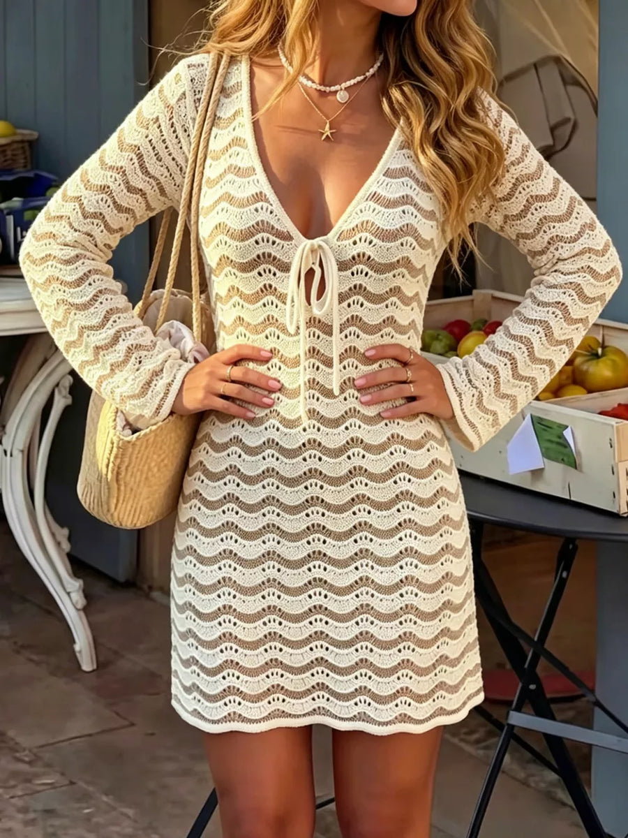 Crochet mini dress with white wave pattern and tie front, long sleeves.