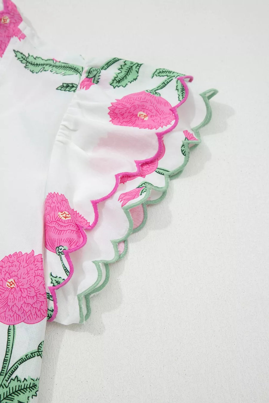 White cotton blouse with pink floral print and scalloped trim sleeves