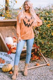 Caramel corduroy sweatshirt with jack-o'-lantern graphic, long sleeves, and crew neck.