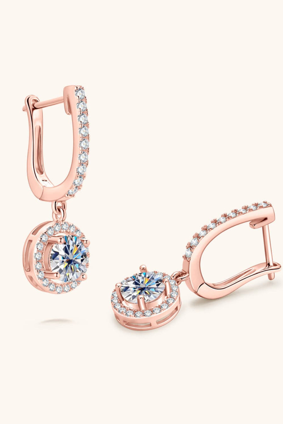 Rose gold pavé halo drop earrings with clear cubic zirconia stones.