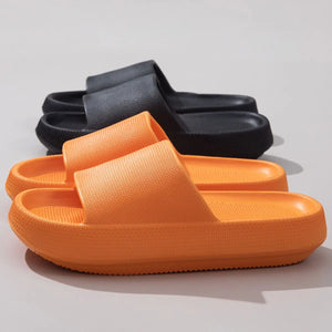 Textured cloud slides slippers in tangerine and black with thick soles.