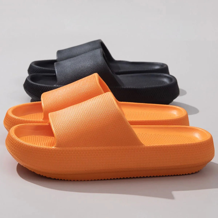 Textured cloud slides slippers in tangerine and black with thick soles.