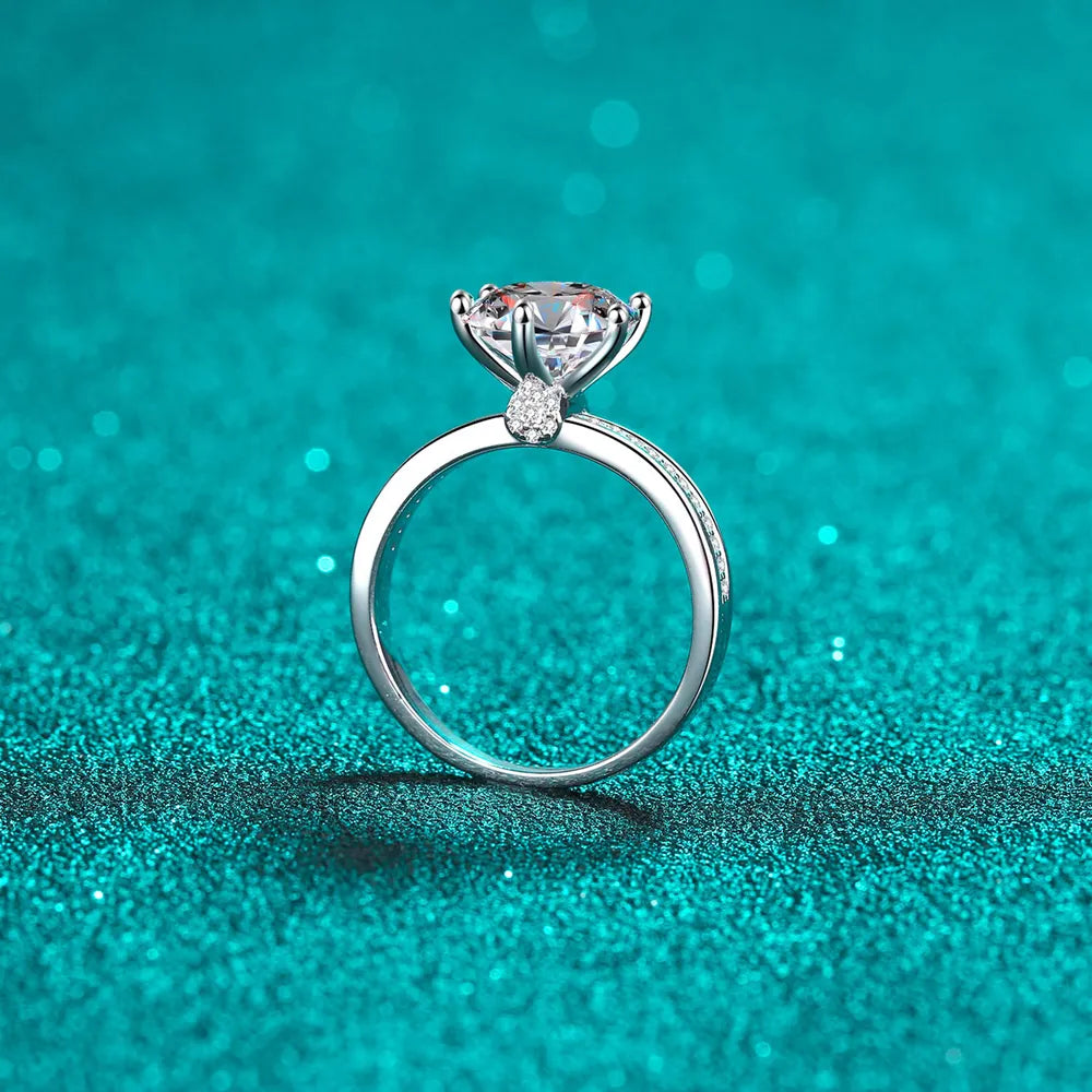 Sterling silver ring with a large moissanite solitaire and pavé band detail.