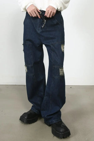 Dark wash denim wide-leg jeans with distressed panel pockets and drawstring waist