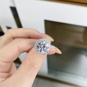 ring in silver featuring halo setting and round fit