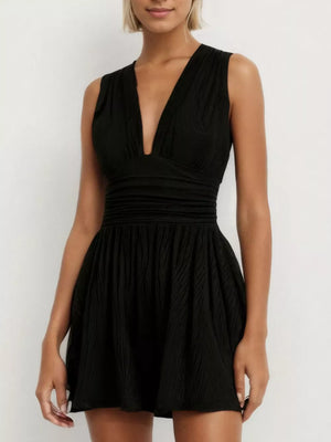 Black ruched deep V-neck romper with cinched waist and textured fabric