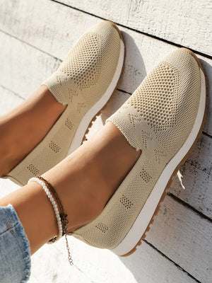 Breathable knit slip-on sneakers in pastel yellow with a diamond pattern.