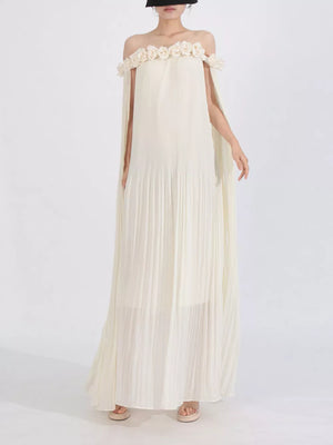 Cream off-shoulder maxi dress with floral applique neckline and cape sleeves.