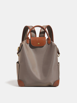 backpack in taupe featuring top handle and structured fit