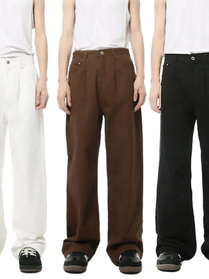 Pleated denim wide-leg trousers in black, chocolate, and ivory.