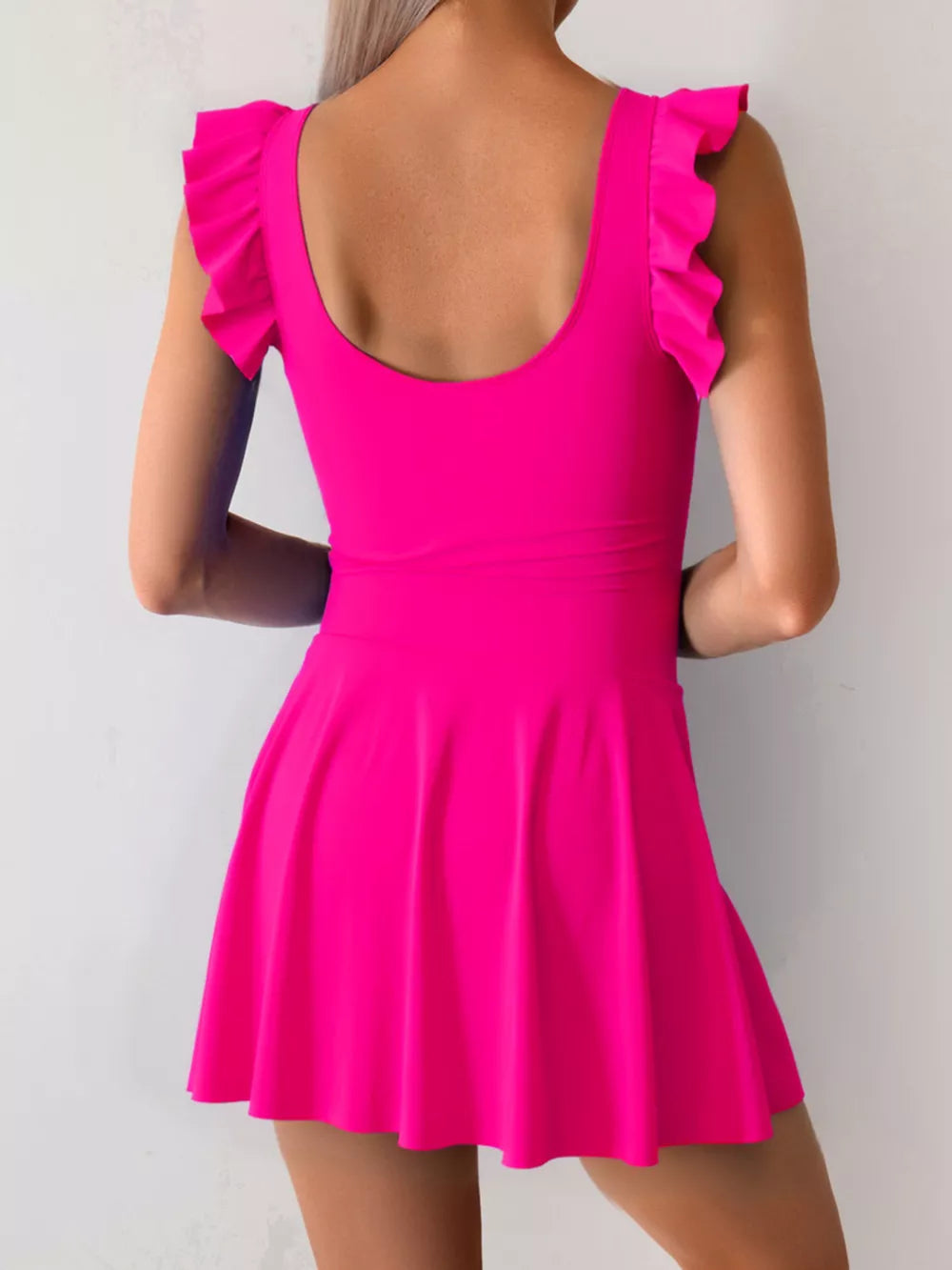 Ruffled sleeve asymmetric swim dress in bright pink with a flared skirt.
