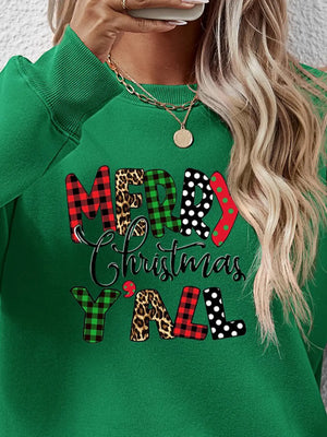 Green crewneck sweatshirt with festive mixed print "Merry Christmas Y'all" graphic.