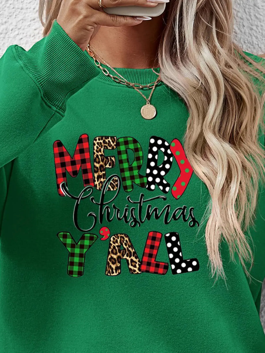 Green crewneck sweatshirt with festive mixed print "Merry Christmas Y'all" graphic.