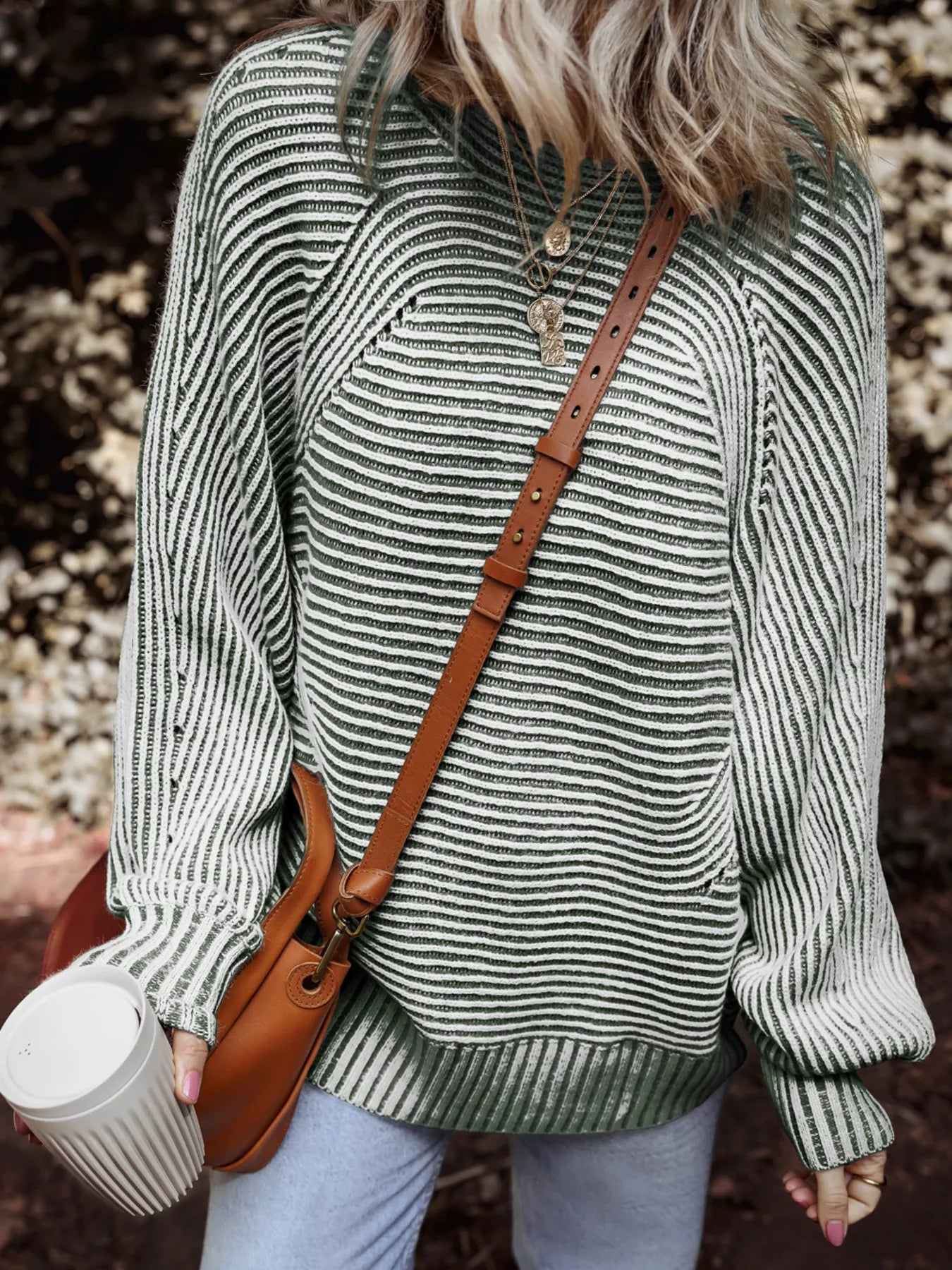 Relaxed ribbed knit sweater with boat neck and stripe pattern in green and white.