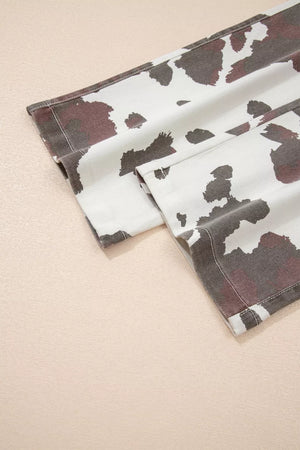 Cow print jeans with utility pockets and a cotton blend fabric.