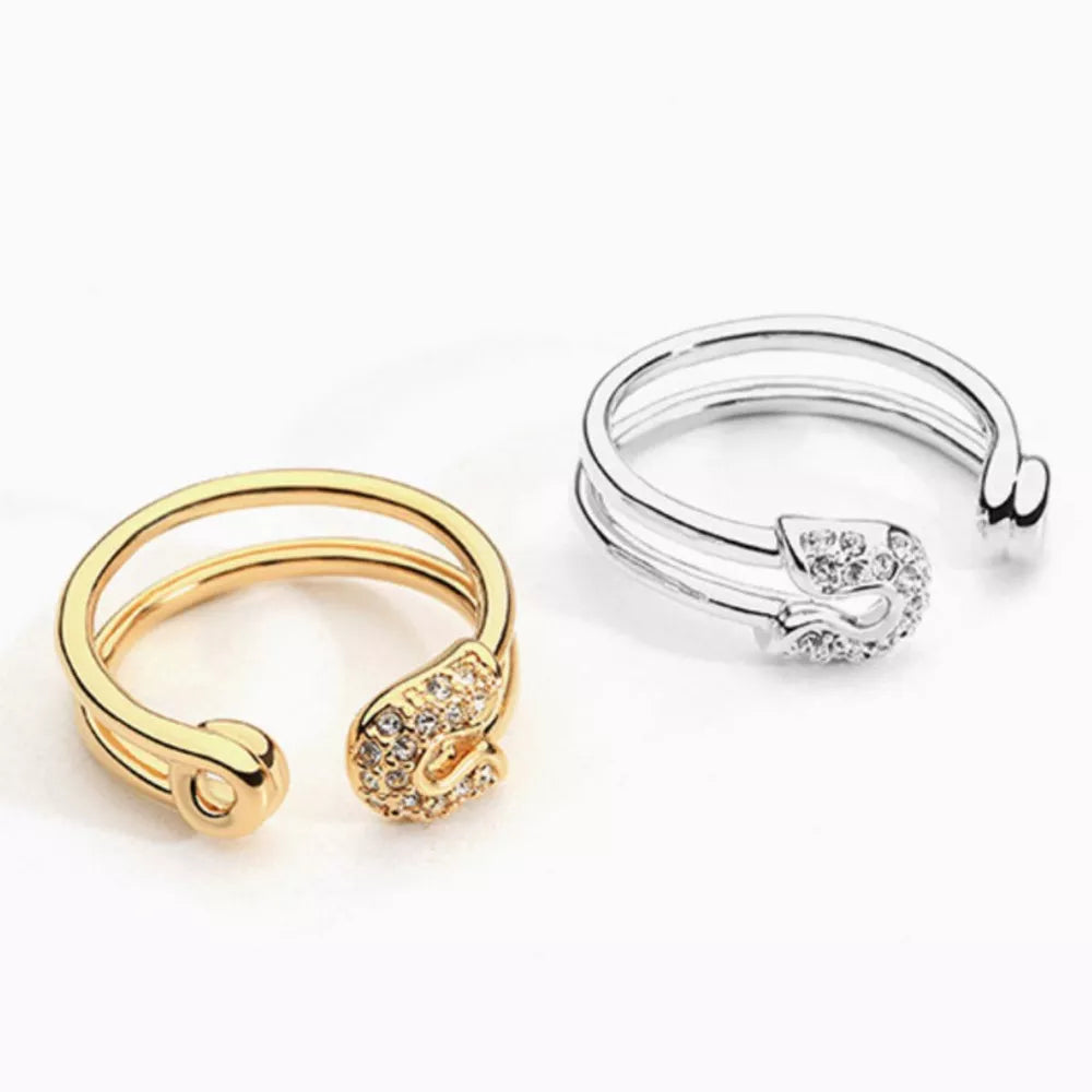 Gold and silver double band rings with zircon-embellished safety pin detail