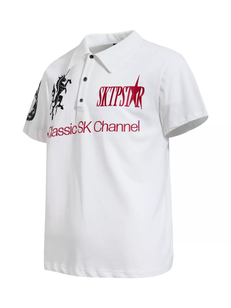 White cotton polo shirt with embroidered mythical creature and text details.
