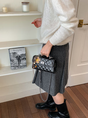 White crossbody bag featuring quilted and quilted