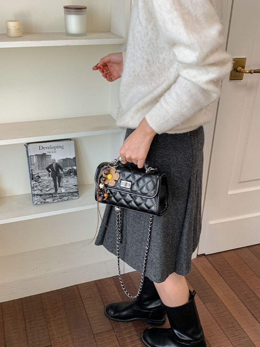 White crossbody bag featuring quilted and quilted