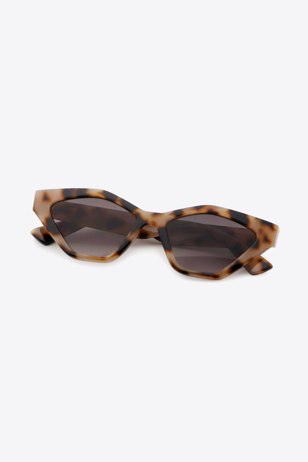 Geometric cat-eye sunglasses in leopard print with dark lenses.