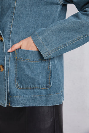 Medium wash denim blazer with tailored seam detailing and button closure.