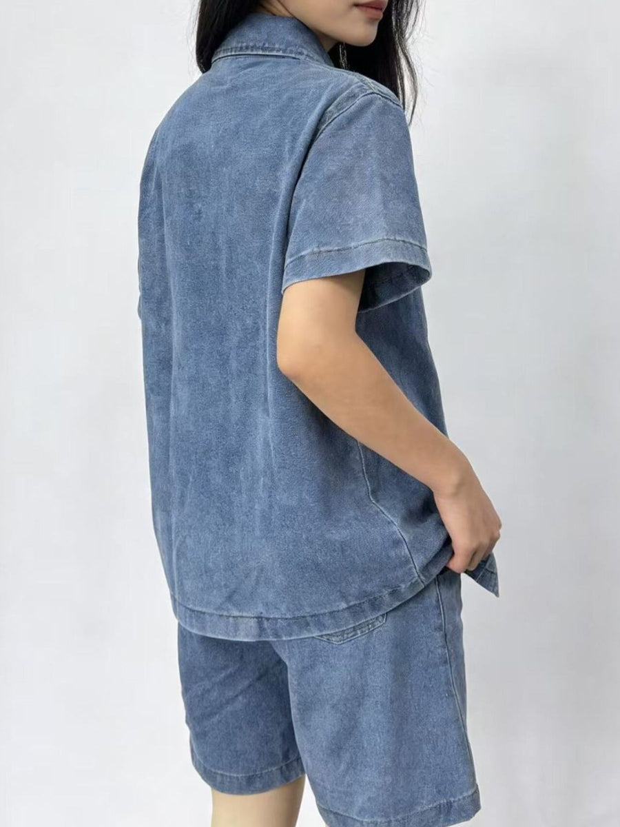 Button-up denim top and shorts set in sky blue, collared, short-sleeve, casual cotton outfit.