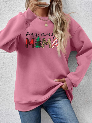 Blush pink long sleeve sweater with "very merry mama" graphic in mixed patterns.