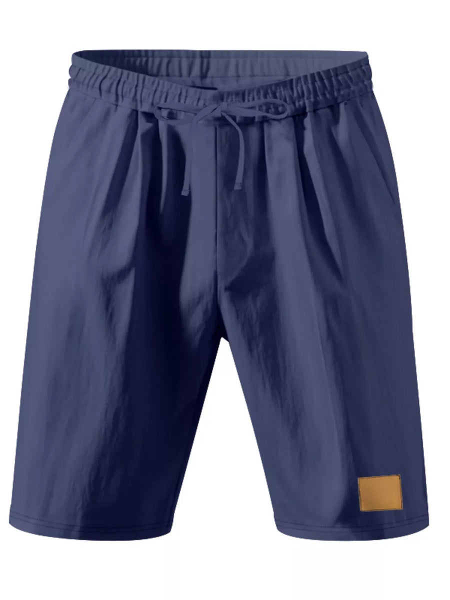 Navy blue chino shorts with drawstring waist and tan patch detail.