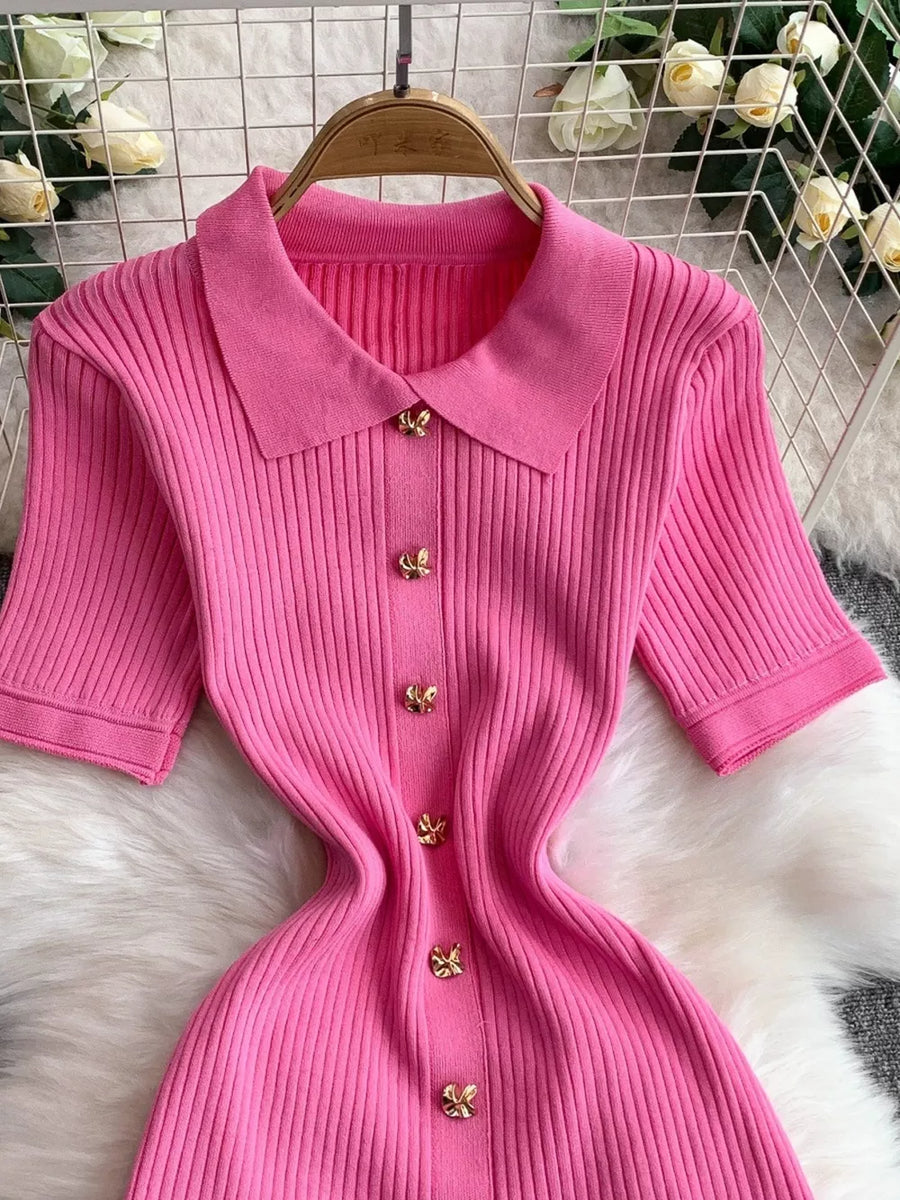 Pink ribbed knit midi dress with collar and gold butterfly button detail.
