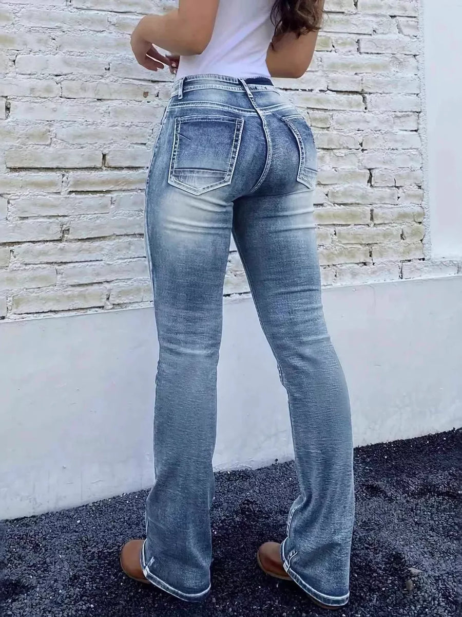 Blue cotton high-waisted bootcut jeans with button closure and distressed detailing.