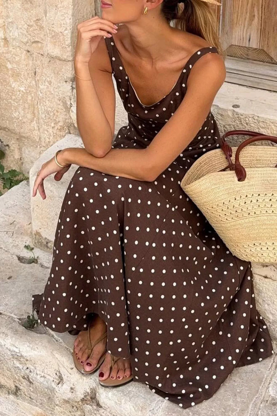 Brown polka dot midi dress with scoop neck and thin straps.