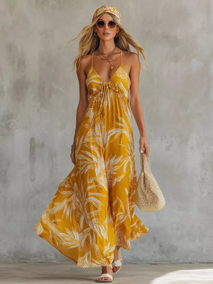 Yellow tropical leaf print maxi dress with spaghetti straps and a tie-front bodice.