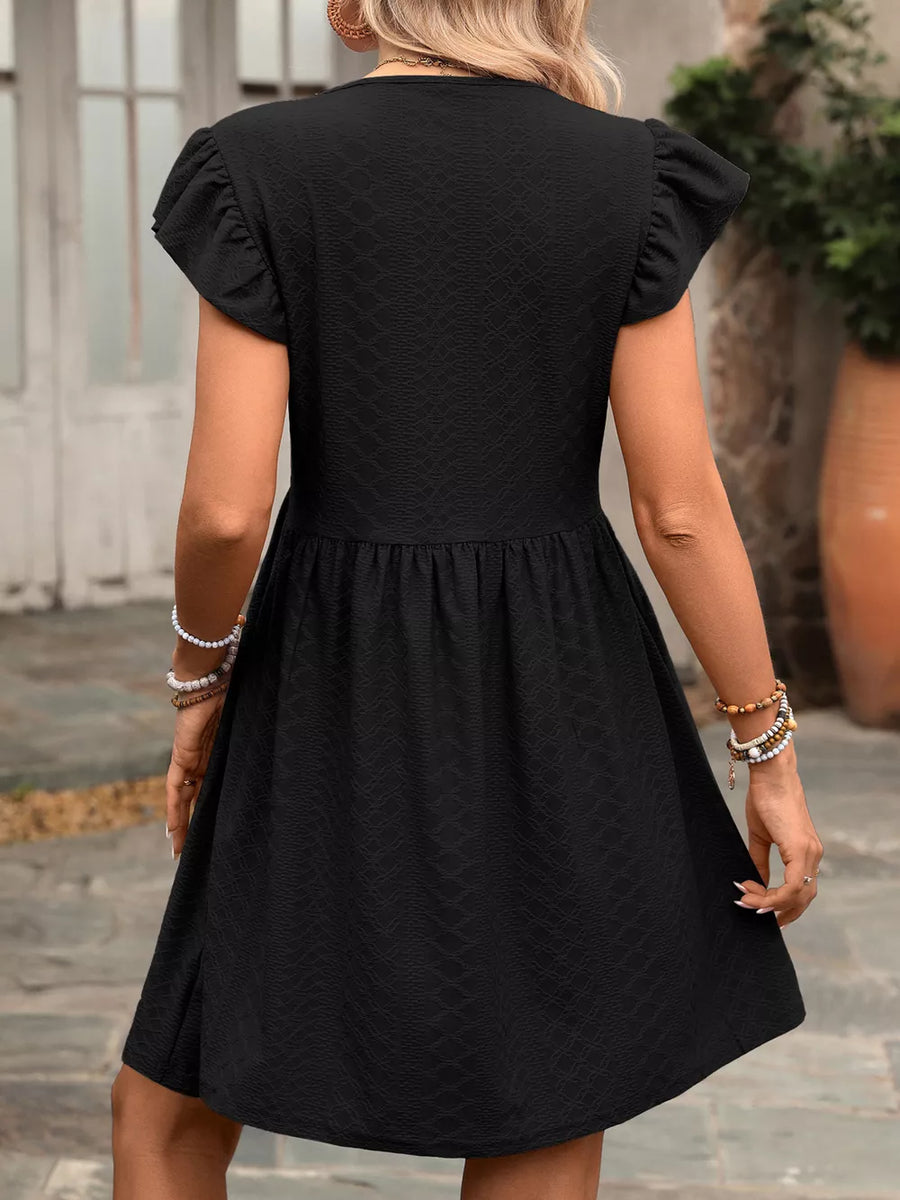 Black a-line dress with ruffled short sleeves and textured fabric.