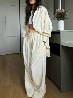 Pinstriped pastel yellow pajama set with button-down shirt and drawstring pants.