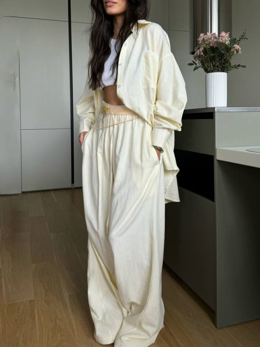Pinstriped pastel yellow pajama set with button-down shirt and drawstring pants.