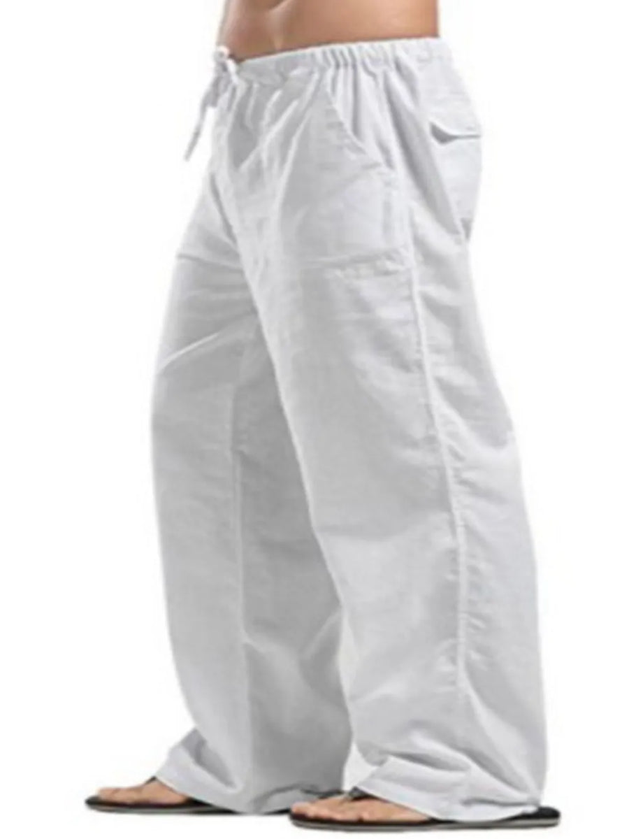 White linen drawstring trousers with pockets and a relaxed fit.