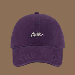 Purple baseball cap with embroidered "Milk" text, casual style
