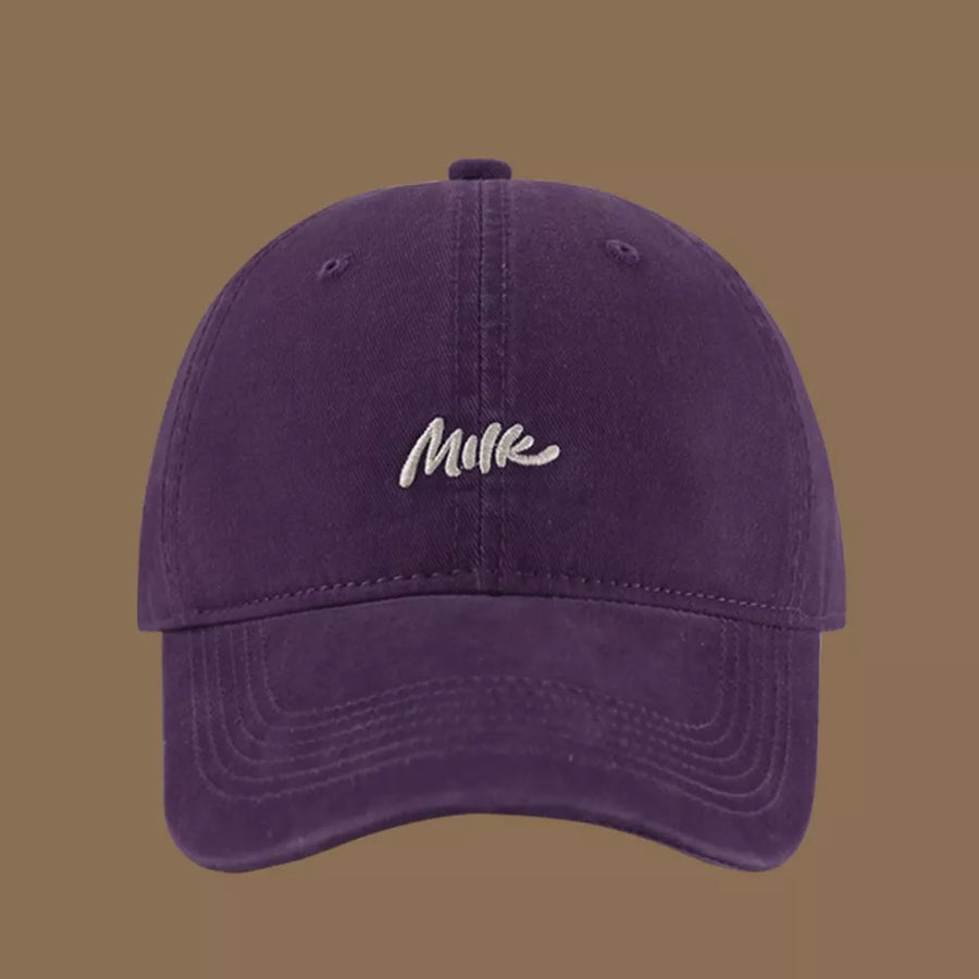 Purple baseball cap with embroidered "Milk" text, casual style