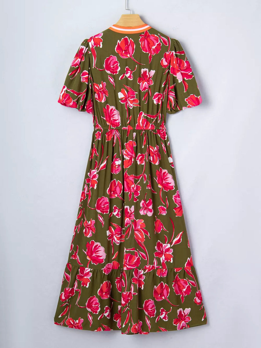 Print split neck dress with short sleeves, elastic waist, and tiered hem in olive green with pink floral print.