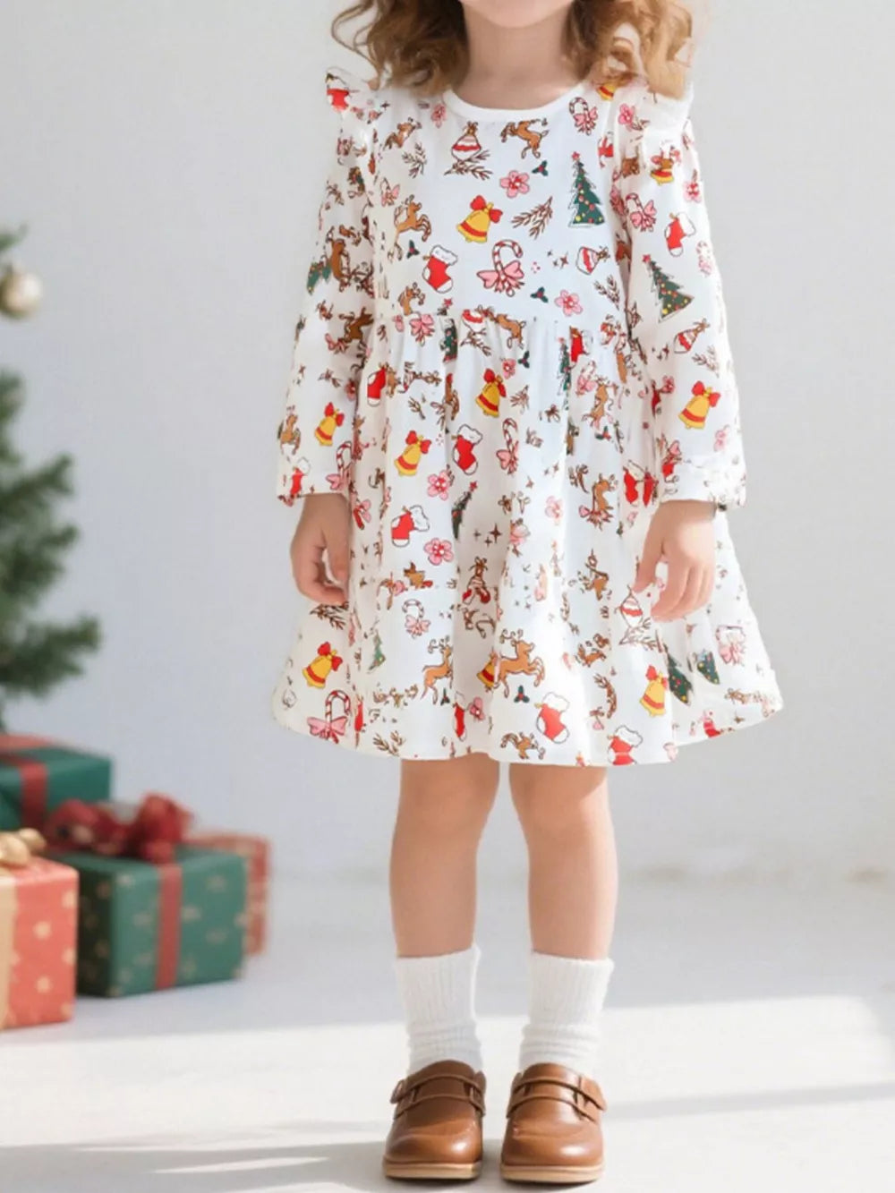 Toddler white cotton dress with festive Christmas print and ruffled sleeves.