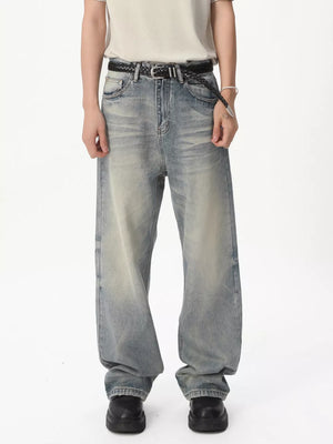 Men's light blue vintage wash wide leg jeans with a braided belt.