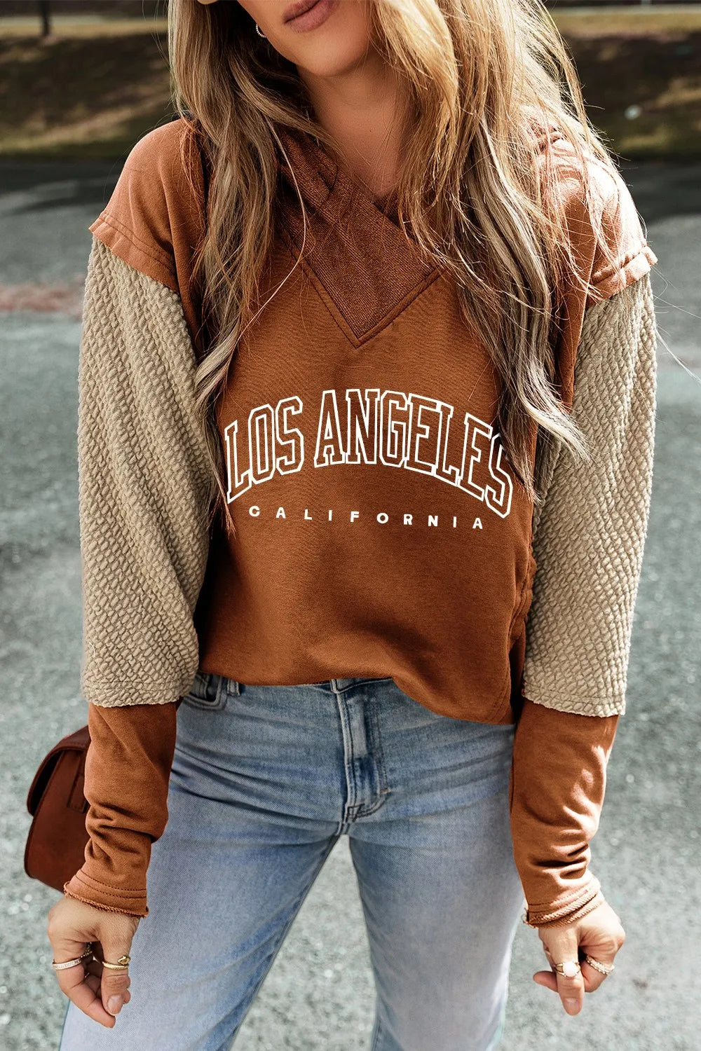 Caramel LA graphic hoodie with textured sleeves and v-neck detail.