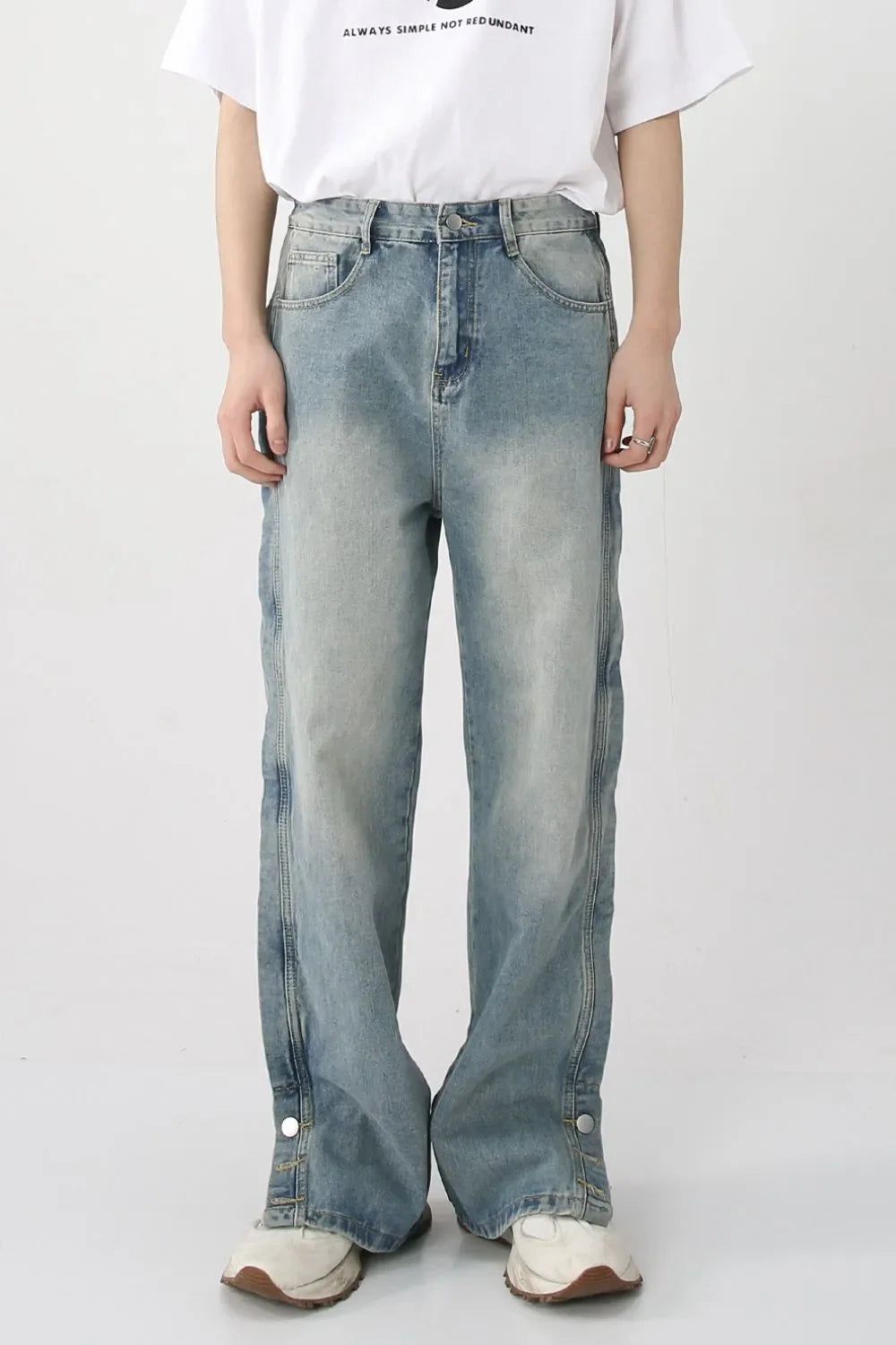 Medium wash baggy denim jeans with snap hem and side slits