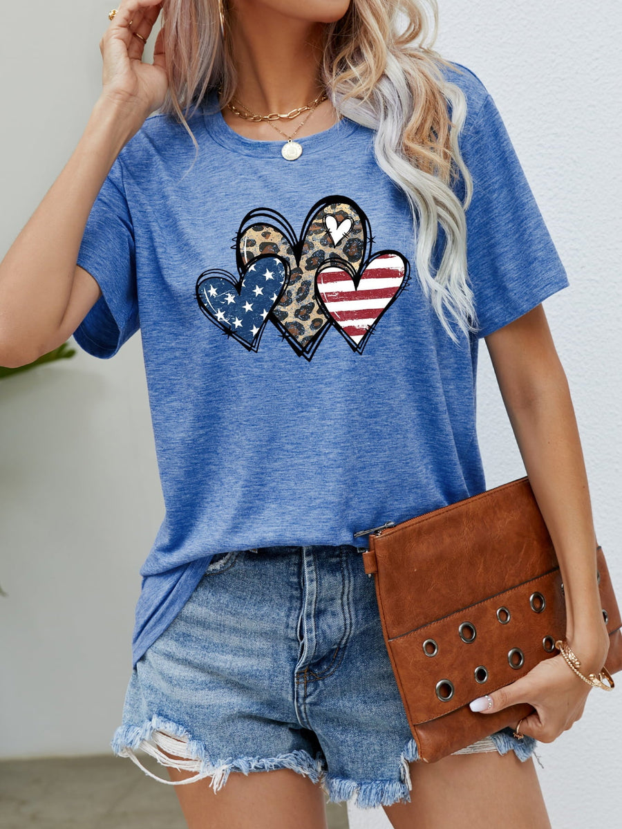 Cobalt blue t-shirt with a graphic of three hearts: one leopard print, one American flag, and one stars and stripes.