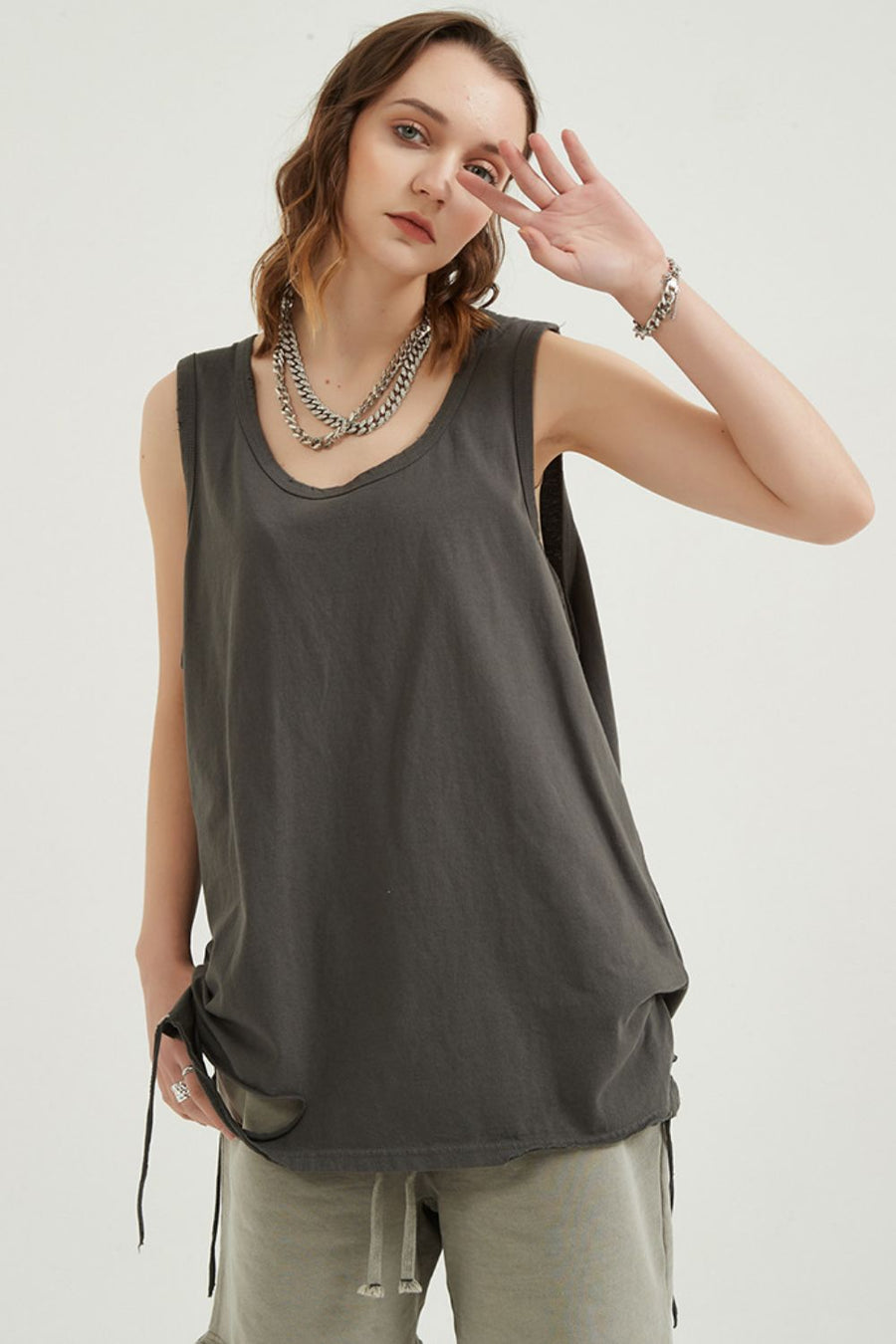 Dark grey sleeveless scoop neck tank top with raw hem and drawstring detail
